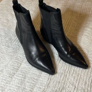 Black pointed boots with 1 1/4 inch heels.